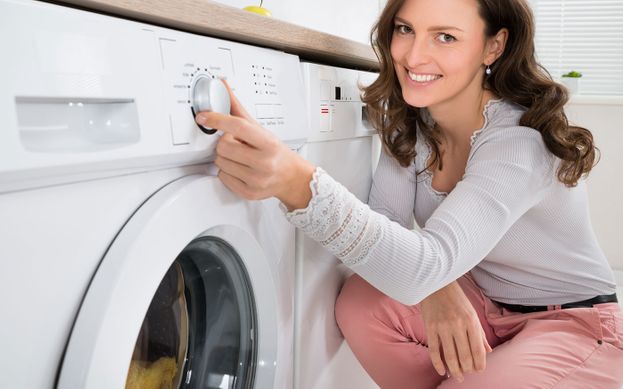 A woman using a washing machine